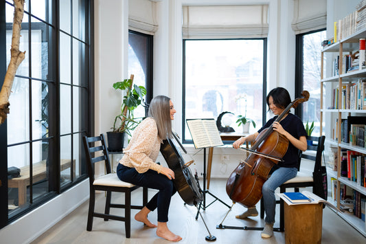 Cello teacher Amber giving student Winter some feedback on her bowing. Feedback is critical in deliberate practice. A good way to get timely and constructive feedback is to have regular lessons.